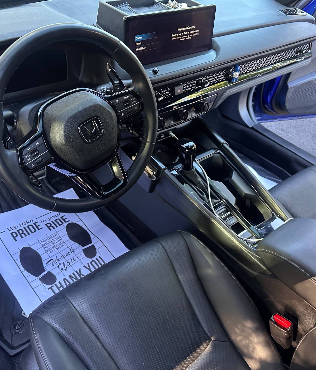 Blue Honda Civic AFTER interior detail by Detail Jockey — clean dashboard, organized console, wiped leather seats and freshly vacuumed floor mat with protective paper cover, NJ⁠