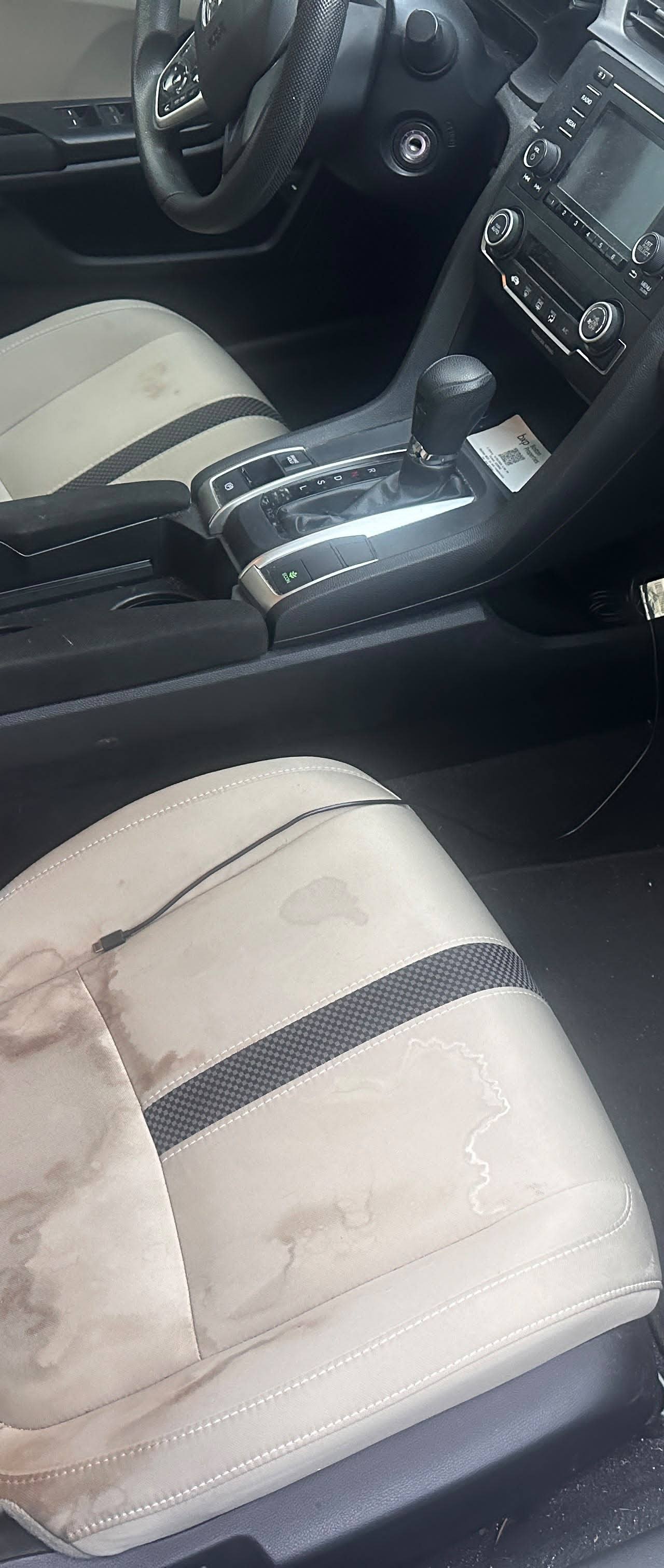 Honda Civic BEFORE interior detail by Detail Jockey — heavily stained beige front passenger seat, dirt spills and dirty floor carpet, NJ⁠