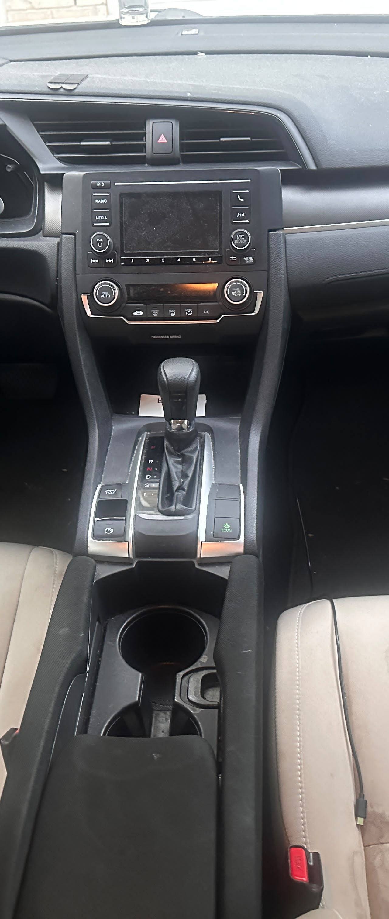 Honda Civic BEFORE interior detail by Detail Jockey — heavily stained beige front seats, dusty dashboard and dirty center console, NJ
